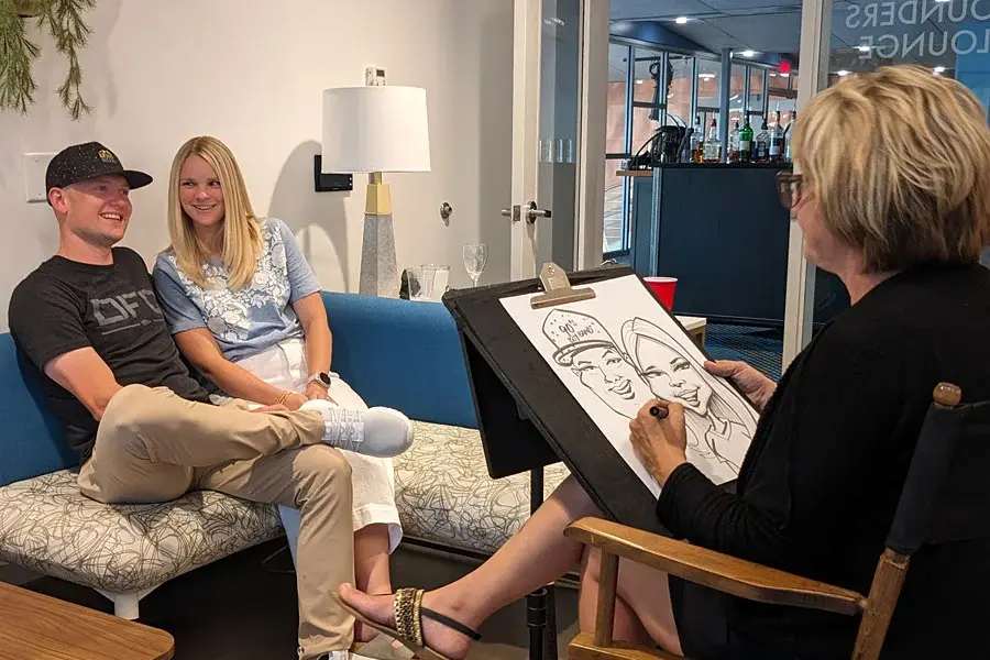 Caricaturist Drawing A Couple At Their Corporate Event