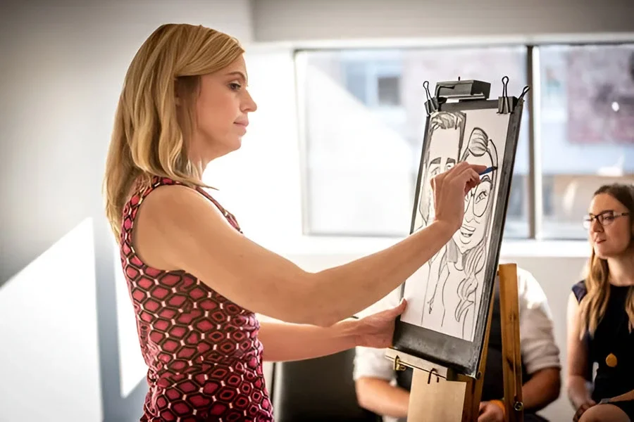 Caricaturist Drawing A Couple At A Wedding Reception