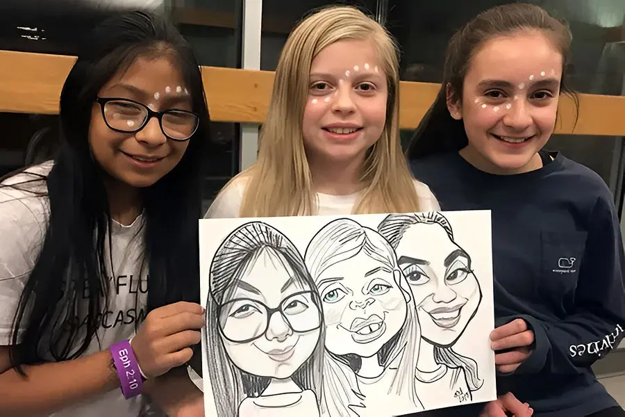 Three Girls Holding Their Group Caricature At A Private Party